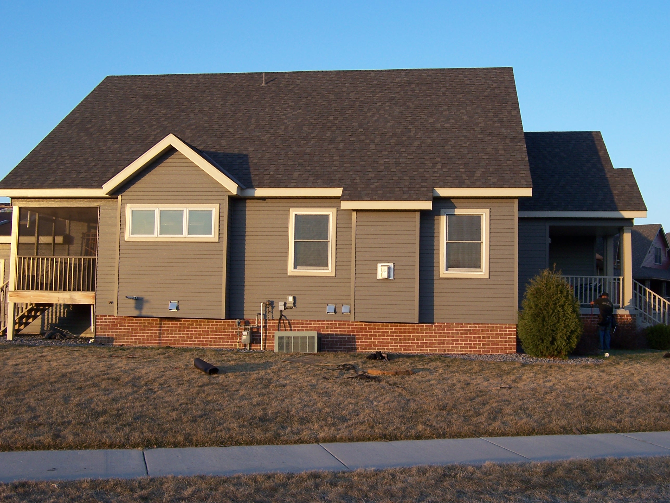 Completed gray LP siding and dark asphalt shingle roof on ranch-style home in Lino Lakes, MN — Northern Forge Construction