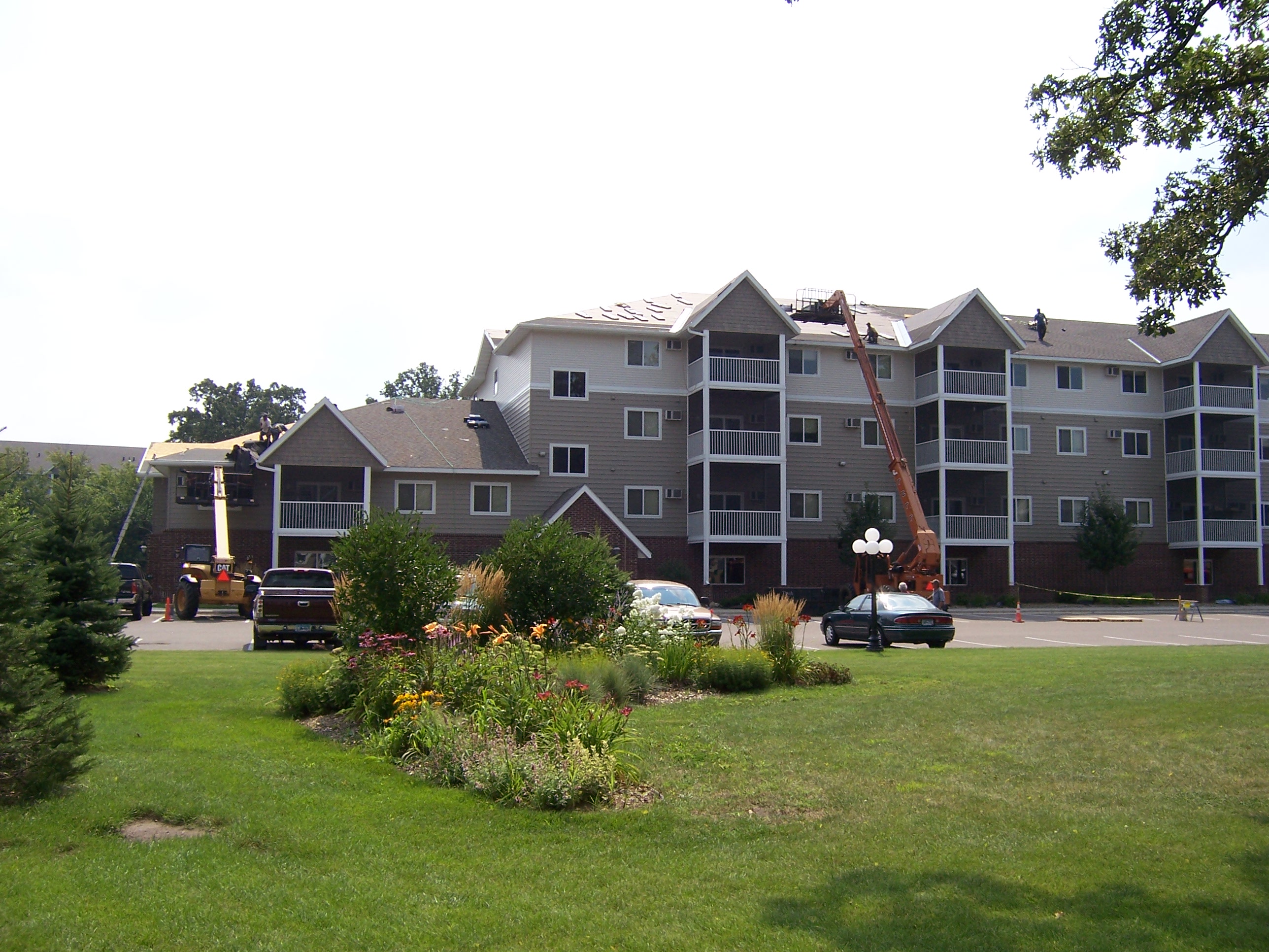 Northern Forge Construction completing multi-unit residential building roof replacement in Blaine, MN — storm damage restoration and HOA roofing services